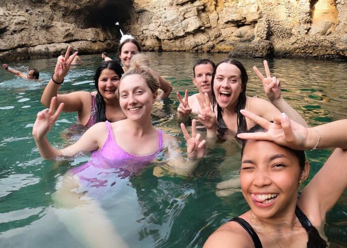 Selfie of a group of women swimming in a secret spot in Sorrento